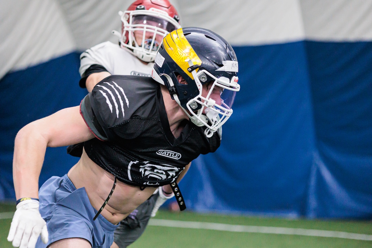 Athlete in pads in a competitive drill at THUD contact level
